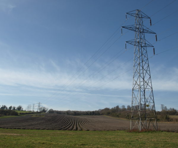 Electricity pylon in a field