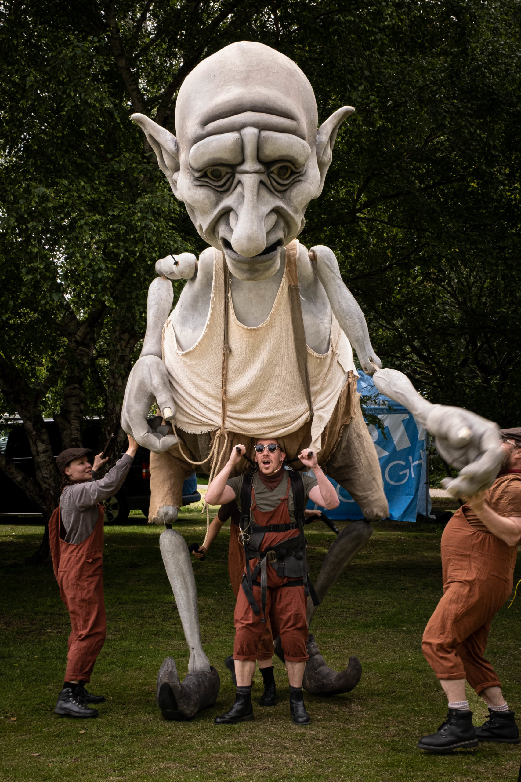 Extra large puppet with three people underneath moving it